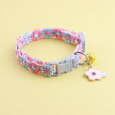 An elegant lace flower cat collar in blue and pink, featuring a gold-tone alloy pendant and a safety bell.