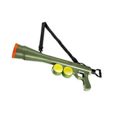 Green dog tennis ball launcher gun shooting multiple tennis balls outdoors.