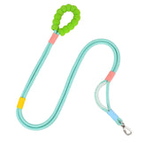 A teal hands‑free dog walking leash with a green padded handle, secure rope design, and metal clip for attachment.