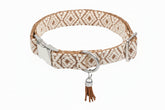 Red and white woven Bohemian dog collar with geometric pattern, metal buckle, D‑ring, and red tassel charm.