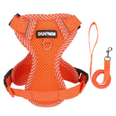A zesty mandarin orange padded mesh puppy harness showing its dual metal D-ring anchors and secure quick-release composite safety buckle closure.