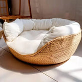Harvest Straw handwoven paper rope cat bed with a white plush cushion inside.