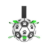 An interactive white dog soccer ball detailed with black paw-print graphics and 9 durable black nylon grab straps for fetching and tug games.