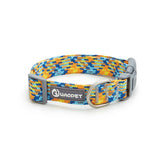 A multi-colored rainbow striped reflective nylon dog collar equipped with a professional-grade heavy-duty metal safety buckle.