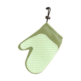 Pet grooming glove with soft brush tips shown removing loose fur from a cat during a gentle grooming session.