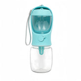 Blue portable pet water bottle with built‑in drinking bowl and transparent water container for outdoor travel.