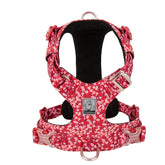 A vibrant Poppy Red dog vest harness featuring a classic white floral pattern with 3M reflective stitching and silver aluminum hardware.