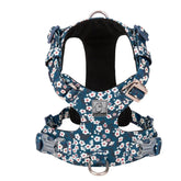 A soft Saxony Blue cotton dog harness with a delicate floral print, showing the adjustable straps and quick-release buckles.