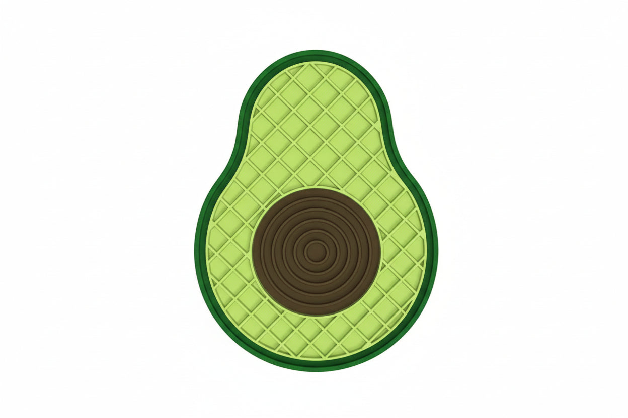 An avocado-shaped silicone licking pad shown on a white background with dimension labels indicating 21 cm height and 16 cm width. A dark brown label in the top left reads 'Avocado Silicone Licking Pad.