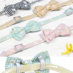 Close-up of the quick-release breakaway safety buckle and the color-matched removable jingle bell on a checkered kitten collar.