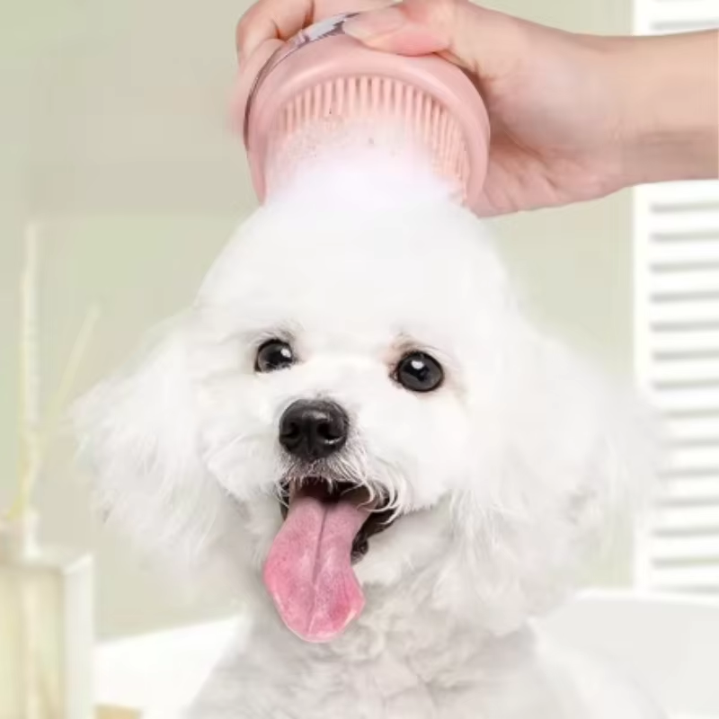 Dog being washed with a turquoise silicone grooming brush during bath time.