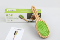 A bamboo double‑sided pet brush featuring soft green silicone bristles, displayed with product box, instruction card, and desiccant packet.
