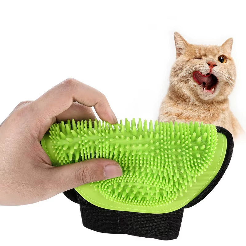 A green pet grooming glove with flexible rubber bristles being held in a hand, designed for massaging and removing loose fur from cats and dogs.