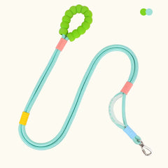 A teal hands‑free dog walking leash with a green padded handle, secure rope design, and metal clip for attachment.