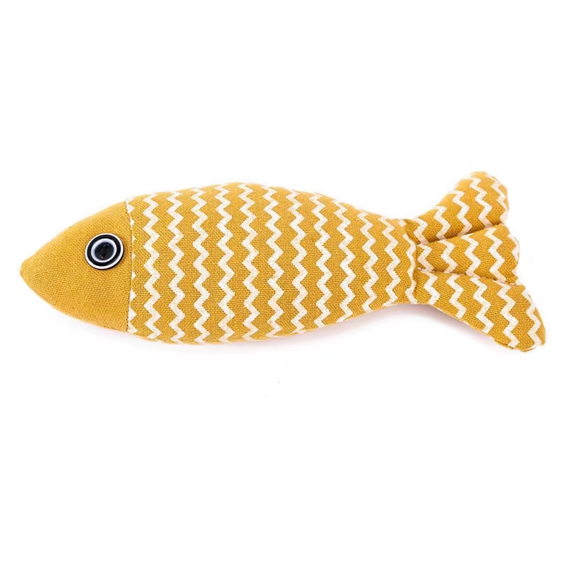 Yellow fish-shaped toy with white zigzag pattern on a white background