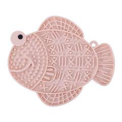 A pink fish-shaped textured silicone lick mat with a suction base for dogs and cats.