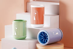 A close-up view of a silicone dog paw cleaning cup showing the soft TPR bristle insert and detachable brush pad used for cleaning pet paws.