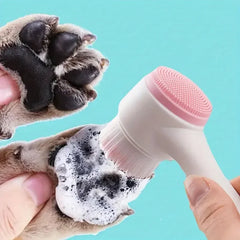 A silicone pet paw cleaning brush with soft bristles being used to wash a pet’s paw with foam, showing gentle cleaning action for dogs and cats.