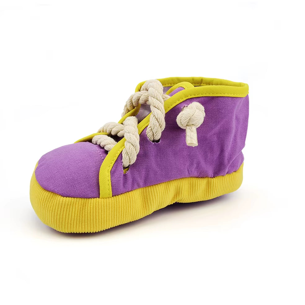 Squeaky shoe shaped dog toy with rope laces for chewing and play