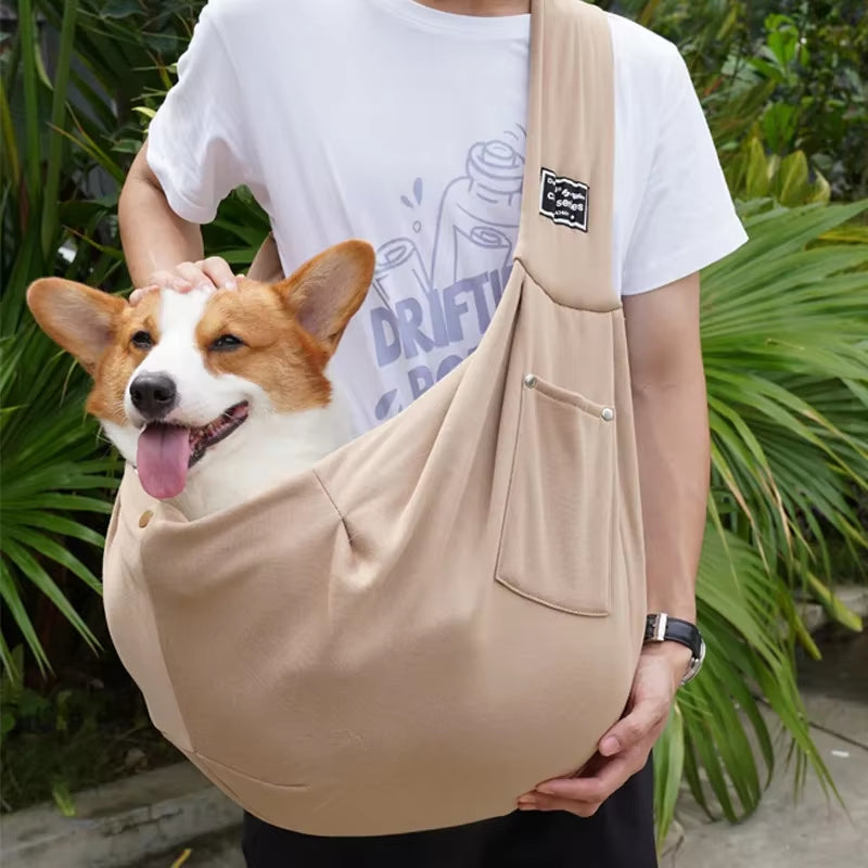 A neutral coyote desert khaki colored pet sling carrier bag demonstrating its comfortable, close-to-body ergonomic tracking profile.