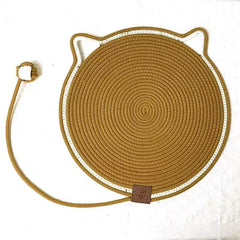 An earth soil brown cat face rope scratching mat showcasing its tightly woven natural fiber texture and integrated knotted tail extension for feline claw care.