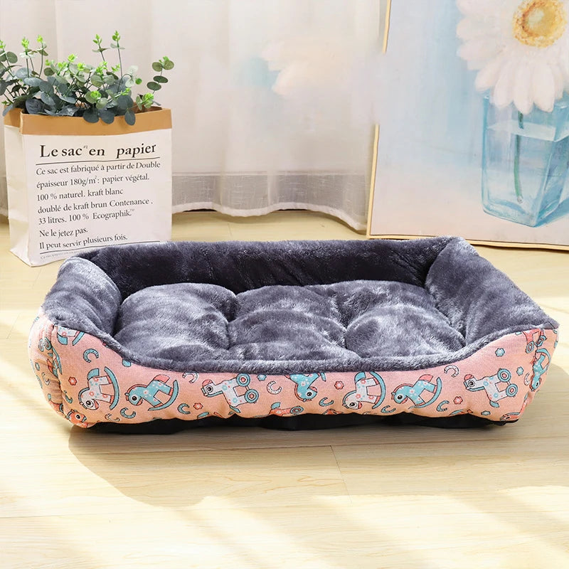 A pink printed winter cushion mat for pets featuring raised bolster edges for neck support.