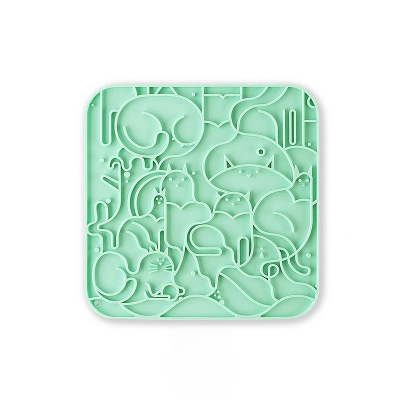 A green textured anti-choking silicone licking mat for dogs and cats with multiple suction cups for secure placement.