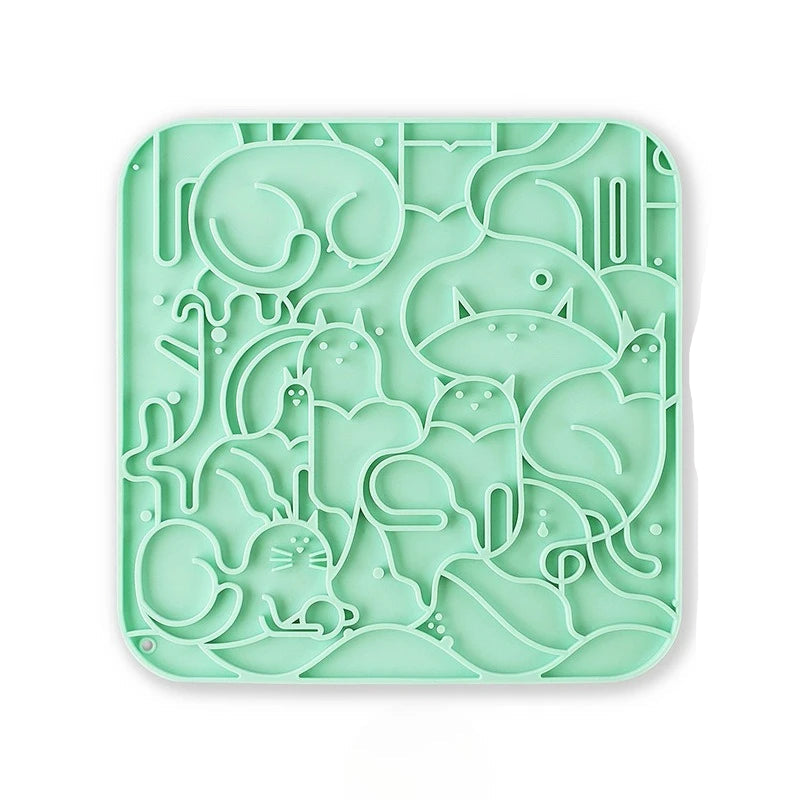 A green textured anti-choking silicone licking mat for dogs and cats with multiple suction cups for secure placement.