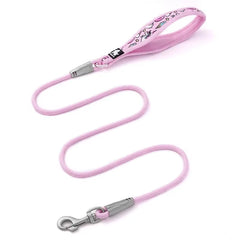 Small to medium dog being walked using a comfortable floral pattern nylon leash with a secure quick-release snap hook.