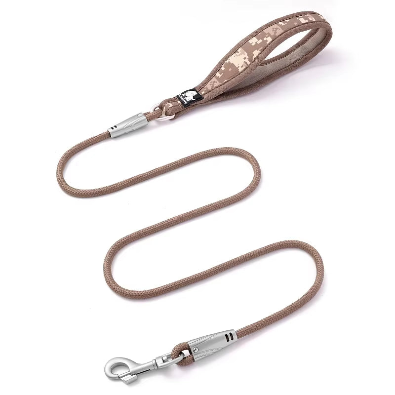 Small to medium dog being walked using a comfortable floral pattern nylon leash with a secure quick-release snap hook.