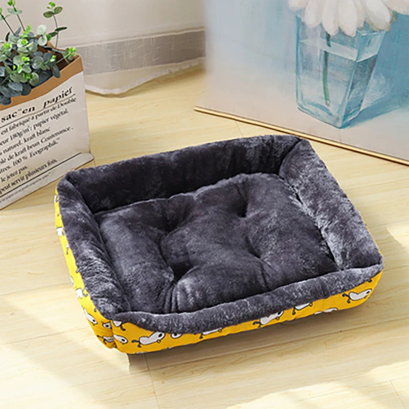 A yellow patterned soft pet sofa bed designed for winter warmth and orthopedic comfort.