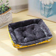A yellow patterned soft pet sofa bed designed for winter warmth and orthopedic comfort.