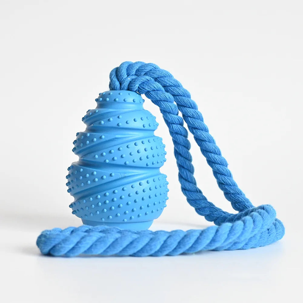An interactive grenade-shaped arctic sky blue rubber dog food leaking educational toy displaying its texturized bumped bite-resistant ridges and hollow treat-dispensing interior core.