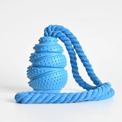 An interactive grenade-shaped arctic sky blue rubber dog food leaking educational toy displaying its texturized bumped bite-resistant ridges and hollow treat-dispensing interior core.