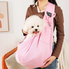 A soft blossom sakura pink hands-free pet sling carrier showcasing its deep open-top pouch designed for small dogs and kittens.