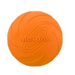 An onyx tangerine orange high-visibility soft flexible outdoor dog fetch frisbee displaying its tooth-safe aerodynamic lip profile.