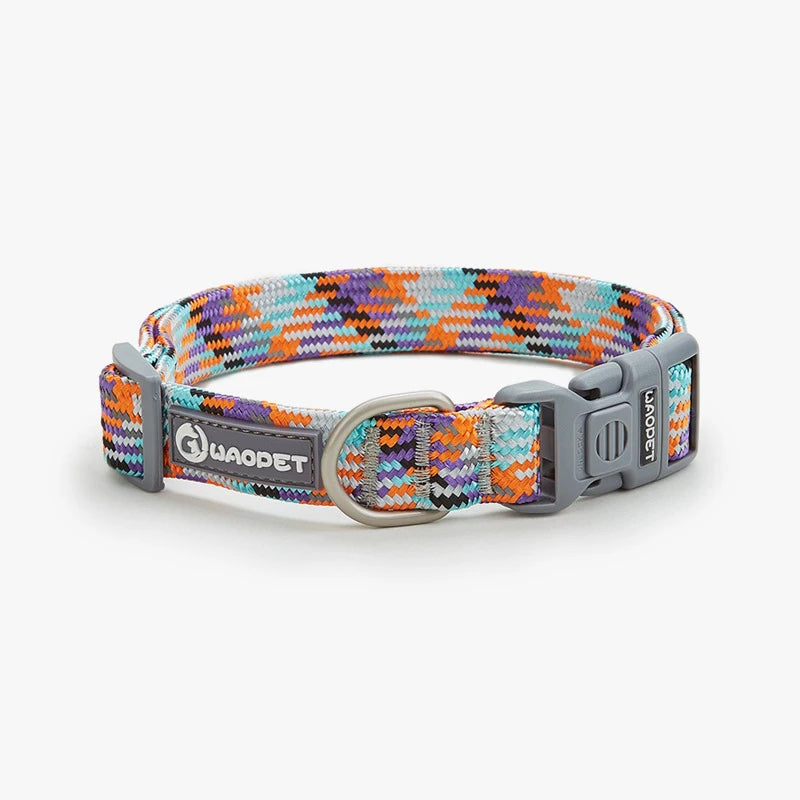 A bright Vibrant Neon Orange reflective safety collar for medium and large dogs showing a secure quick-release metal buckle and steel D-ring.