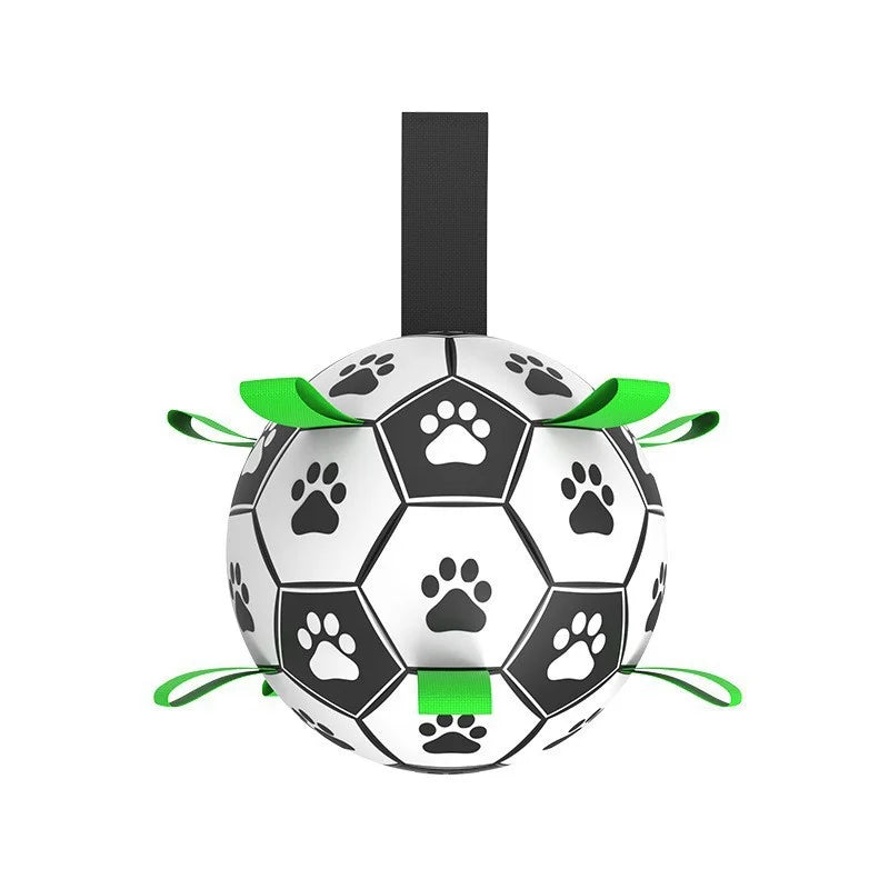 An interactive white dog soccer ball detailed with black paw-print graphics and 9 durable black nylon grab straps for fetching and tug games.