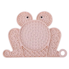 A pink frog-shaped textured silicone licking mat for dogs and cats featuring a strong suction base.