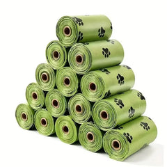 Multiple rolls of large, green pet waste bags containing 15 bags per roll for hygienic dog and cat cleanup.