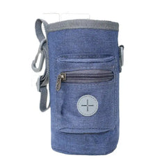 A portable dark grey Oxford pet training waist bag with compartments for snacks and waste bags for outdoor dog training.