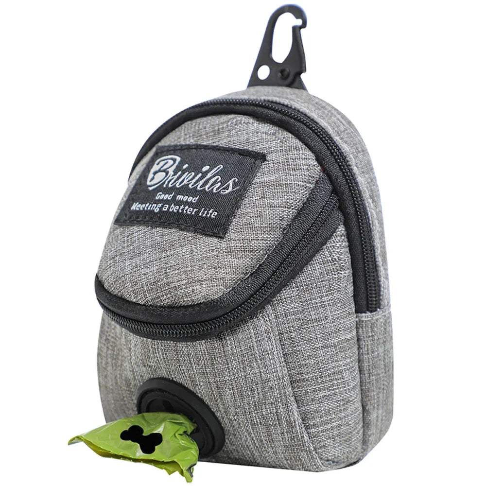 A slate grey portable dog training treat pouch with a waist strap and an integrated waste bag dispenser for outdoor pet rewards.