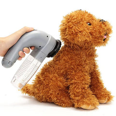 Handheld view of the chemical-free plastic pet deshedding vacuum running gently along a cat’s coat to capture loose undercoat fur and dander.