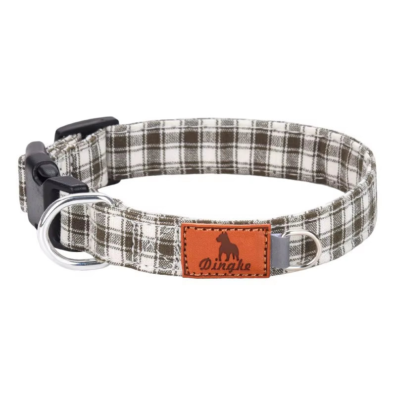 Brown and white plaid dog collar with soft polyester webbing, black buckle, metal D‑ring, and leather patch.