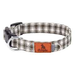Brown and white plaid dog collar with soft polyester webbing, black buckle, metal D‑ring, and leather patch.