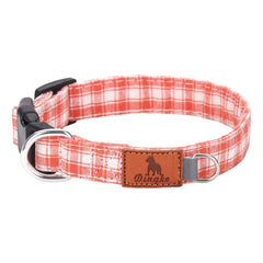 Brown and white plaid dog collar with soft polyester webbing, black buckle, metal D‑ring, and leather patch.