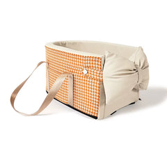Orange houndstooth pet car seat with beige bow and padded interior, designed for transporting small dogs and cats.