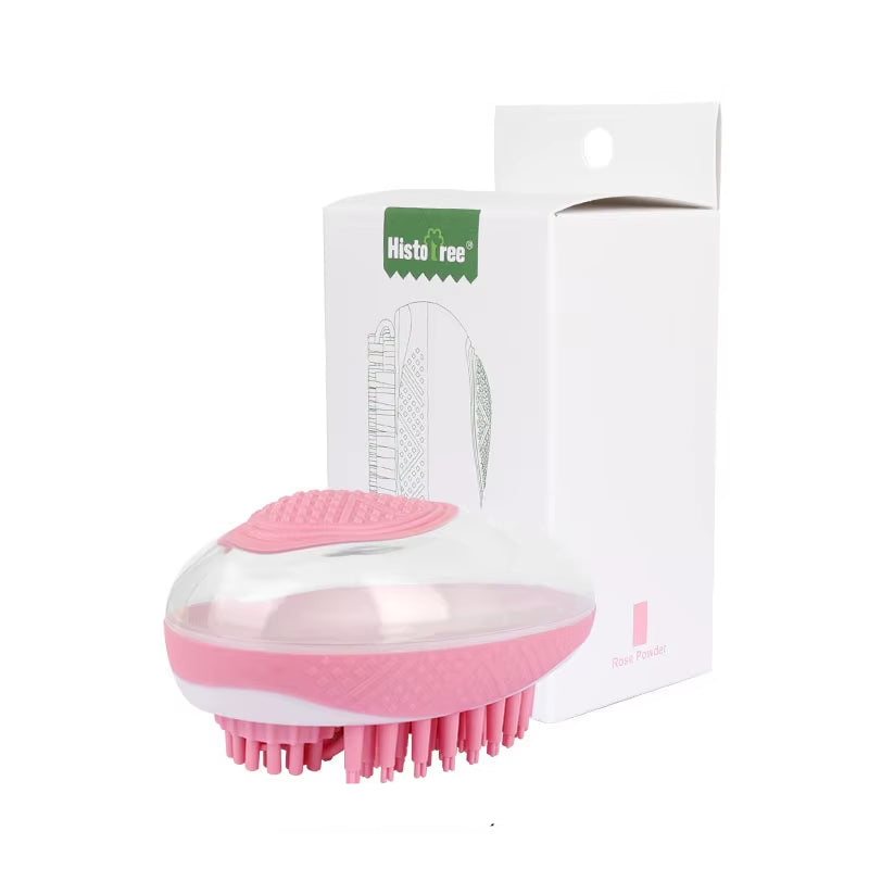 A blossom sakura pink portable pet shower comb laid flat to showcase the compact, dual-action cleaning and massaging bristle layout.