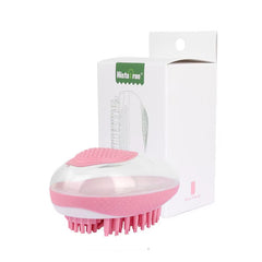 A blossom sakura pink portable pet shower comb laid flat to showcase the compact, dual-action cleaning and massaging bristle layout.