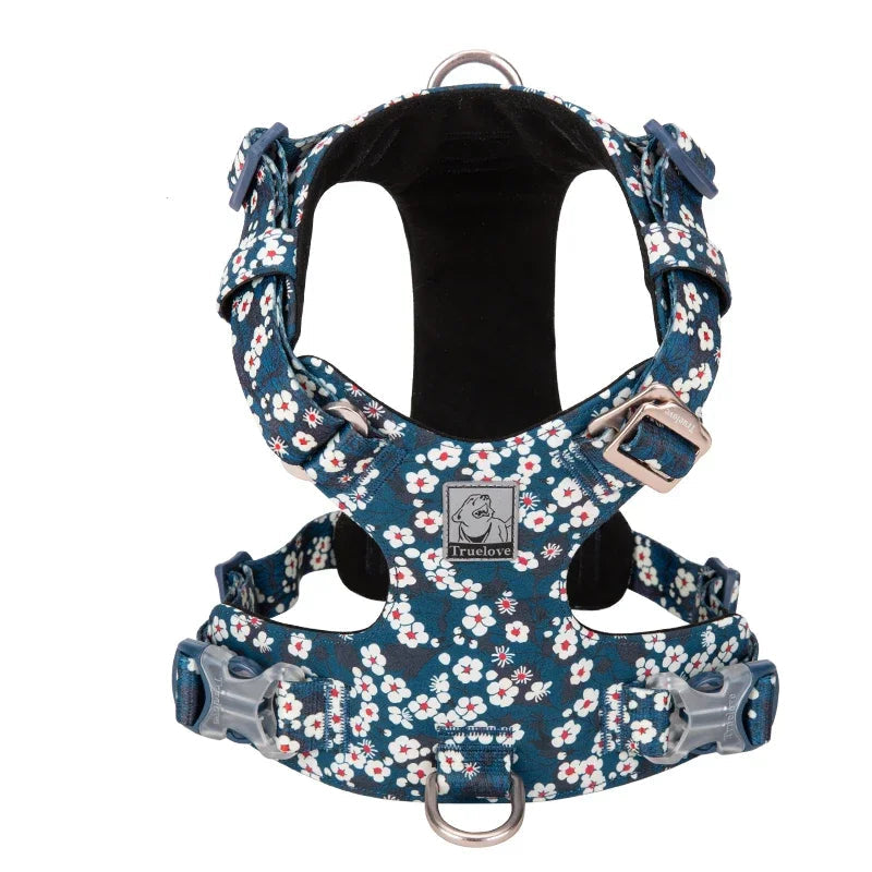 A soft Saxony Blue cotton dog harness with a delicate floral print, showing the adjustable straps and quick-release buckles.